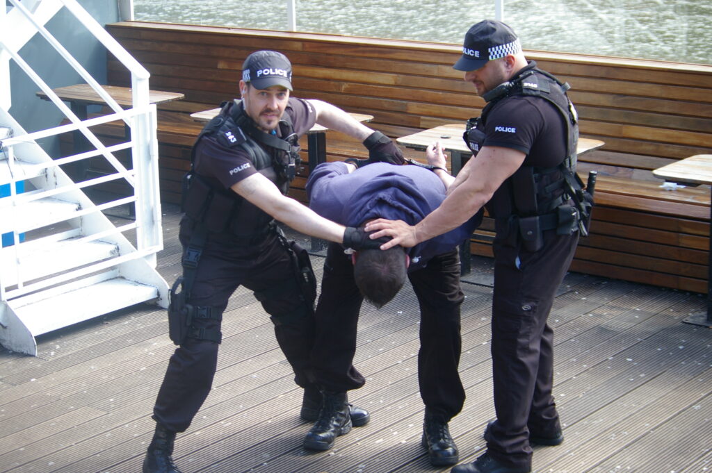 Training supporting Artists how to safely restrain a suspect for the movie Instant Death